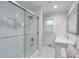 Bright bathroom features white subway tiles in the shower, glass door, modern vanity, and framed mirror at 1590 Arden Sw Dr, Marietta, GA 30008
