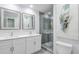 Modern bathroom with dual vanities, stylish mirrors, and a glass-enclosed walk-in shower at 1590 Arden Sw Dr, Marietta, GA 30008