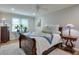 Inviting bedroom with a bed, decorative lamps, and a window offering natural light at 1590 Arden Sw Dr, Marietta, GA 30008