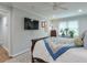 Comfortable bedroom with a mounted TV, a decorative quilt, and a bright window at 1590 Arden Sw Dr, Marietta, GA 30008