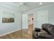 Cozy bedroom showcasing hardwood floors, neutral wall paint, and access to the kitchen and closet at 1590 Arden Sw Dr, Marietta, GA 30008