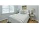 Bright bedroom features a comfortable bed, two bedside tables, and a large window at 1590 Arden Sw Dr, Marietta, GA 30008