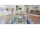 Charming dining area features a modern table and chairs, complemented by white cabinets and hardwood floors at 1590 Arden Sw Dr, Marietta, GA 30008
