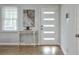 Modern entryway featuring a stylish white door with translucent panes and a decorative table at 1590 Arden Sw Dr, Marietta, GA 30008