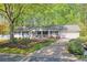 Charming ranch-style home with a well-manicured front yard and a welcoming porch at 1590 Arden Sw Dr, Marietta, GA 30008