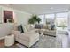 Bright living room with a plush sectional sofa, area rug, and views of the outdoors through large windows at 1590 Arden Sw Dr, Marietta, GA 30008
