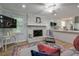 Cozy living room featuring a white brick fireplace and open access to the kitchen at 1590 Arden Sw Dr, Marietta, GA 30008