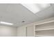 Finished basement ceiling with fluorescent lighting and built-in shelving, offering potential for added living space at 2685 Hearthstone Cir, Marietta, GA 30062
