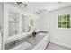 Bathroom featuring double sinks with granite counters and white cabinets, plus a view to the outdoors at 2685 Hearthstone Cir, Marietta, GA 30062