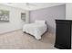 Spacious bedroom with a brick accent wall, neutral carpet, and bright natural light at 2685 Hearthstone Cir, Marietta, GA 30062