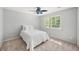 Light-filled bedroom features neutral carpet, ceiling fan, a bright window, and a bed with plush pillows at 2685 Hearthstone Cir, Marietta, GA 30062