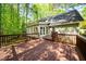 Large wooden deck with railing, ideal for outdoor dining and enjoying scenic views of the surrounding greenery at 2685 Hearthstone Cir, Marietta, GA 30062