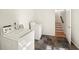 Laundry room featuring a washer and dryer with mixed tile floor and stairs to the second level at 2685 Hearthstone Cir, Marietta, GA 30062