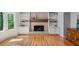 Inviting living room featuring a brick fireplace with built-in shelving and natural light at 2685 Hearthstone Cir, Marietta, GA 30062
