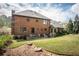 Well-maintained backyard with a patio area, lush lawn, and mature trees, ideal for outdoor entertaining at 393 Westminister Sw Ln, Lilburn, GA 30047