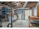 Unfinished basement with exposed beams and a white door to the backyard at 393 Westminister Sw Ln, Lilburn, GA 30047
