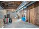 Unfinished basement with exposed pipes, rafters, and partially insulated walls, offers potential for customization at 393 Westminister Sw Ln, Lilburn, GA 30047