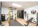 Finished basement with workout equipment, mirrors, and a suspended ceiling at 393 Westminister Sw Ln, Lilburn, GA 30047