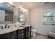Modern bathroom featuring dual vanities, stylish mirrors, and plenty of natural light at 393 Westminister Sw Ln, Lilburn, GA 30047
