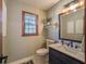 Charming bathroom featuring a wooden-framed window, vanity, and a decorative mirror at 393 Westminister Sw Ln, Lilburn, GA 30047