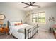 Cozy bedroom featuring a queen bed, ceiling fan, and a bright window at 393 Westminister Sw Ln, Lilburn, GA 30047