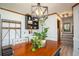 Charming dining area with a modern light fixture and staircase access at 393 Westminister Sw Ln, Lilburn, GA 30047