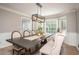 Bright dining area with ample windows, contemporary lighting, and comfortable seating at 393 Westminister Sw Ln, Lilburn, GA 30047