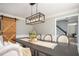 Dining area with modern lighting and a rustic barn door, perfect for entertaining at 393 Westminister Sw Ln, Lilburn, GA 30047