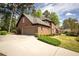 A well-maintained home with a brick exterior, attached garage, and paved driveway at 393 Westminister Sw Ln, Lilburn, GA 30047