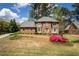 Charming two-story brick home with a manicured lawn and mature landscaping at 393 Westminister Sw Ln, Lilburn, GA 30047