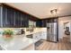 Updated kitchen with black and white cabinets, stainless steel appliances and stylish countertops at 393 Westminister Sw Ln, Lilburn, GA 30047