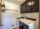 Functional laundry room featuring a washer, dryer, and ample storage space at 393 Westminister Sw Ln, Lilburn, GA 30047