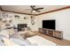 Comfortable living room with a fireplace, built-in shelving, and a ceiling fan provides a relaxing atmosphere at 393 Westminister Sw Ln, Lilburn, GA 30047