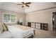 Bright main bedroom featuring a trey ceiling, ceiling fan, and stylish shelving at 393 Westminister Sw Ln, Lilburn, GA 30047