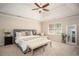 Spacious main bedroom with a trey ceiling, ceiling fan, and ample natural light from the window at 393 Westminister Sw Ln, Lilburn, GA 30047