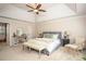Serene main bedroom featuring a trey ceiling, ceiling fan, a sitting area and ensuite bathroom at 393 Westminister Sw Ln, Lilburn, GA 30047