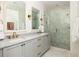 Luxury bathroom featuring dual sinks, marble countertops, and a glass-enclosed shower, showcasing elegance and functionality at 77 Delmont Ne Dr, Atlanta, GA 30305