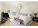 Serene bedroom with a plush rug, modern lighting fixture, and a comfortable bed at 77 Delmont Ne Dr, Atlanta, GA 30305