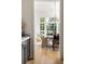Open concept dining room with modern lighting fixtures and hardwood floors at 77 Delmont Ne Dr, Atlanta, GA 30305
