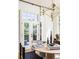 Airy dining room featuring modern light fixture and large windows, next to French doors to a patio at 77 Delmont Ne Dr, Atlanta, GA 30305