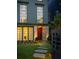 Inviting home exterior with stone path, wood door, and well-manicured lawn and landscaping at 77 Delmont Ne Dr, Atlanta, GA 30305