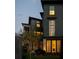 Charming multi-story home with lush landscaping, a stone path, and warm exterior lighting at 77 Delmont Ne Dr, Atlanta, GA 30305