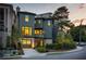 Beautiful two-story home with a three-car garage and lush landscaping showcasing curb appeal at sunset at 77 Delmont Ne Dr, Atlanta, GA 30305