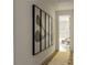 Bright hallway featuring modern artwork and hardwood floors leading to a cozy bedroom area at 77 Delmont Ne Dr, Atlanta, GA 30305