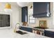 Kitchen with island, marble countertops, custom range hood, and stainless appliances at 77 Delmont Ne Dr, Atlanta, GA 30305