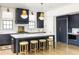 Kitchen with island, counter seating, stainless appliances, and custom cabinetry at 77 Delmont Ne Dr, Atlanta, GA 30305