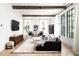 Spacious living room features high ceilings, exposed beams, and ample natural light from large windows at 77 Delmont Ne Dr, Atlanta, GA 30305