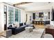Open concept living room and kitchen with an expansive sectional sofa and neutral accents at 77 Delmont Ne Dr, Atlanta, GA 30305