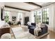 Bright living room with large windows, modern decor, and a comfortable seating area at 77 Delmont Ne Dr, Atlanta, GA 30305