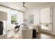 Bright home office with modern desk, white chairs, large window, and elegant decor at 77 Delmont Ne Dr, Atlanta, GA 30305